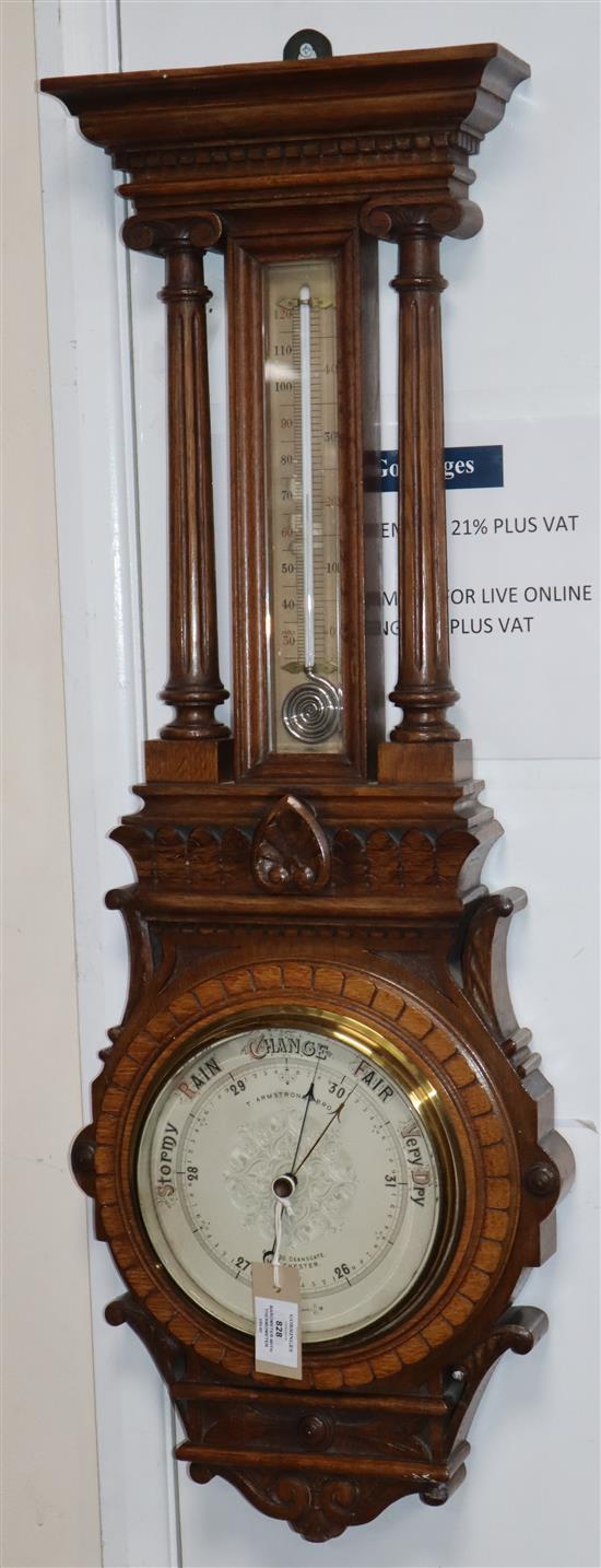 A Victorian carved oak aneroid barometer with thermometer H.92cm